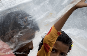 Two people bracing rain during Monsoon in Bangladesh - dpa Two people bracing rain during Monsoon in Bangladesh - dpa